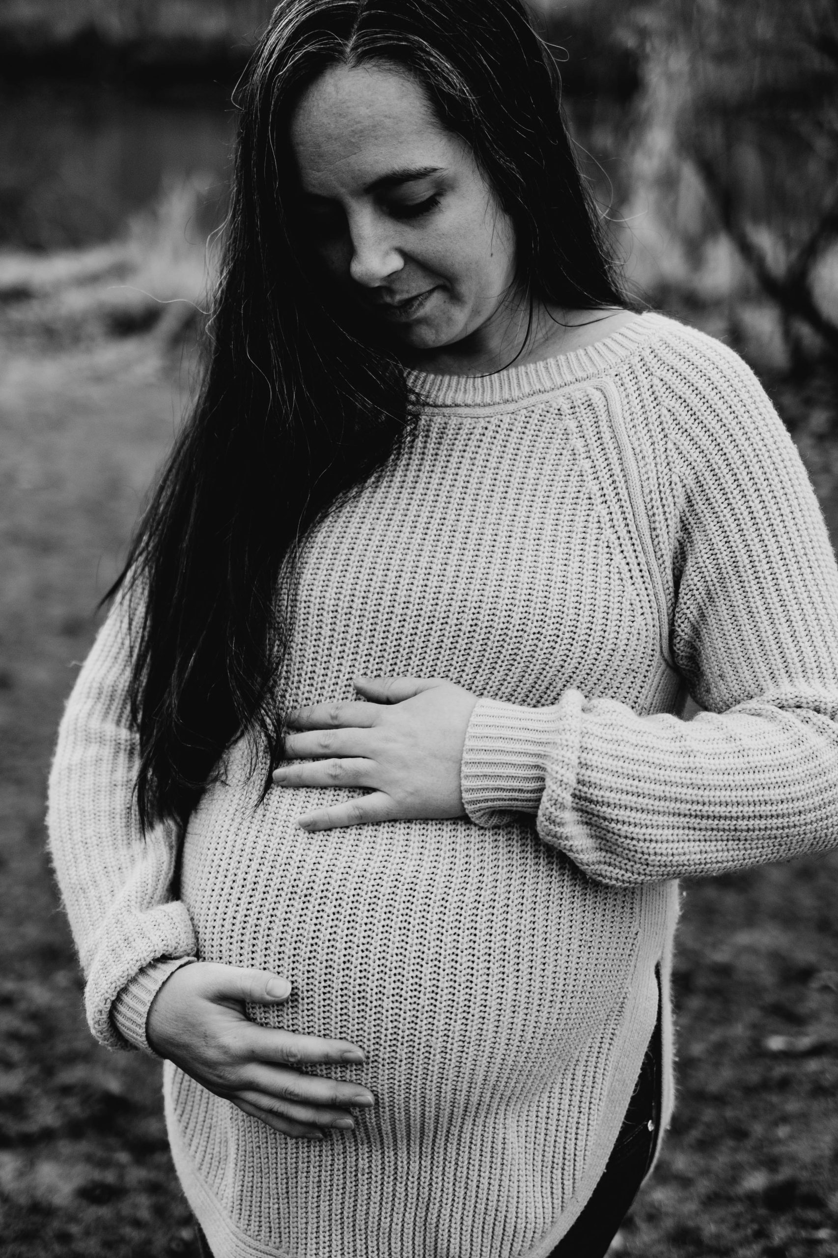 Devan standing holding pregnant belly